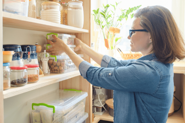 Woman stocking her pantry